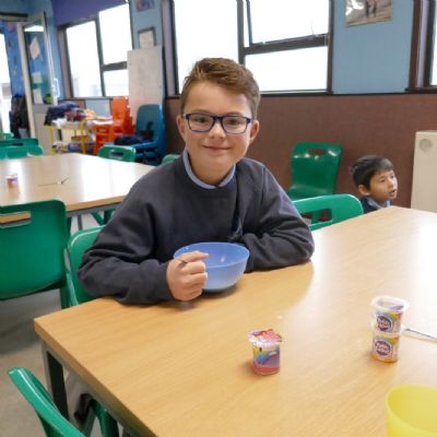 A pupil enjoying breakfast