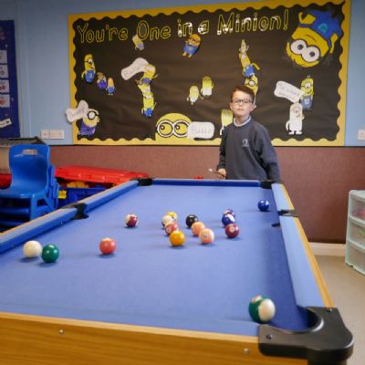 A pupil playing pool