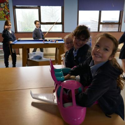 3 pupils in the foreground and 2 in the background all playing