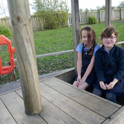 Two pupils sitting in the wooden train