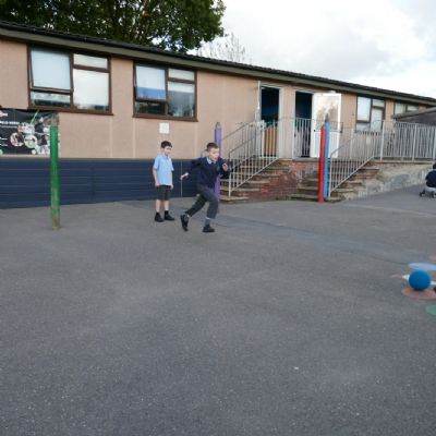 Two pupils playing football