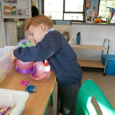 One pupil playing with a pink toy
