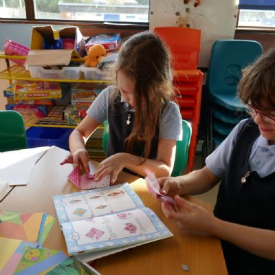 Two pupils practising their origami